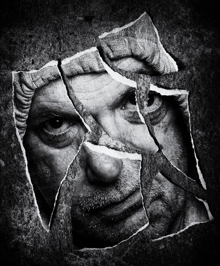 ct2 A man's face is shown through a hole in the wall.