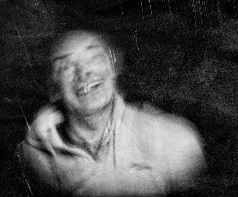 ct4 A black and white photo of a man laughing.