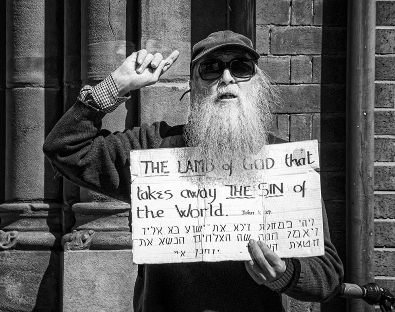 Photographs of the coronavirus lockdown-06 A man with a beard holding up a sign.