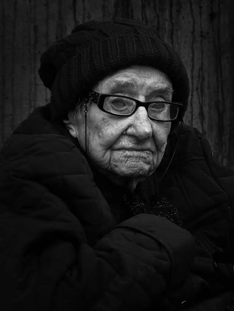 Faces_Photo_by John Gill-37 A black and white photo of an old woman.