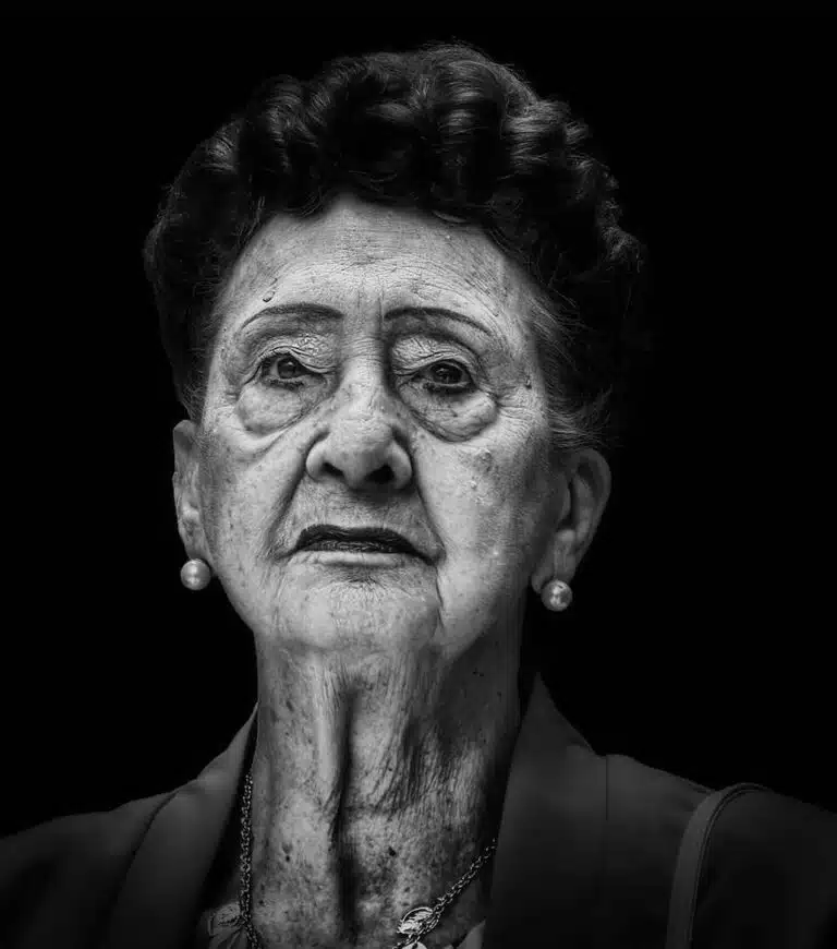 Faces_Photo_by John Gill-44 A black and white photo of an old woman.