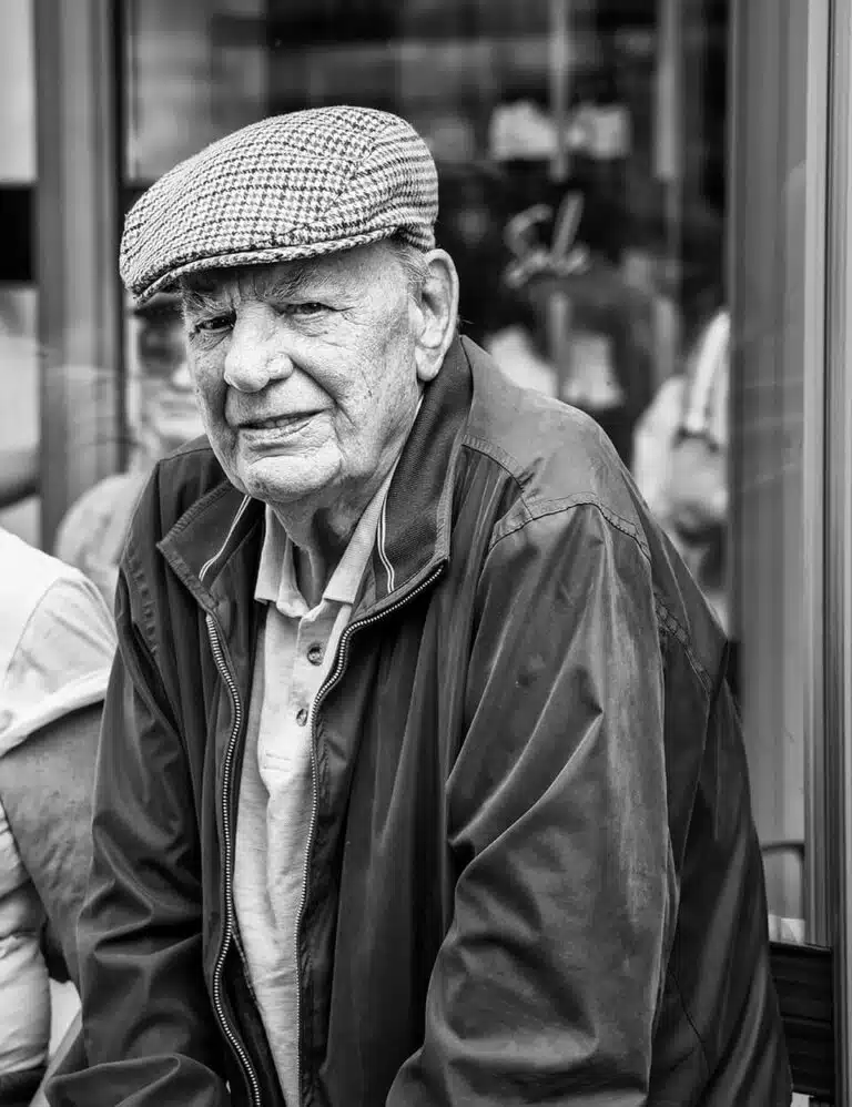 Leeds-Pride-2019-22 A black and white photo of an older man sitting on a bench.