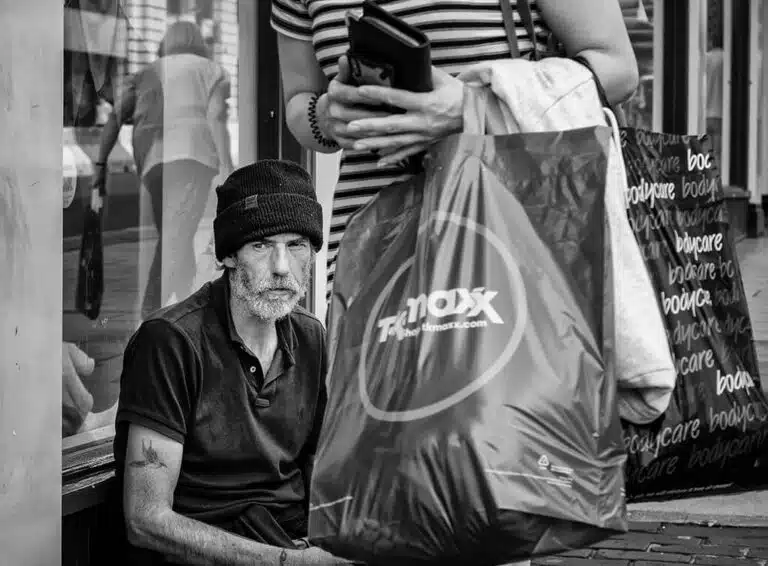 Leeds-Pride-2019-29 A black and white photo of a woman sitting on the sidewalk.