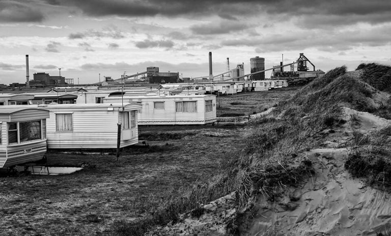 Redcar street photograph-15 A black and white photo of mobile homes in the sand.