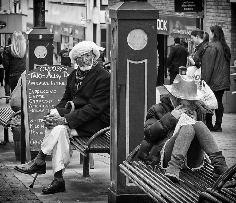 A man is sitting on a bench.