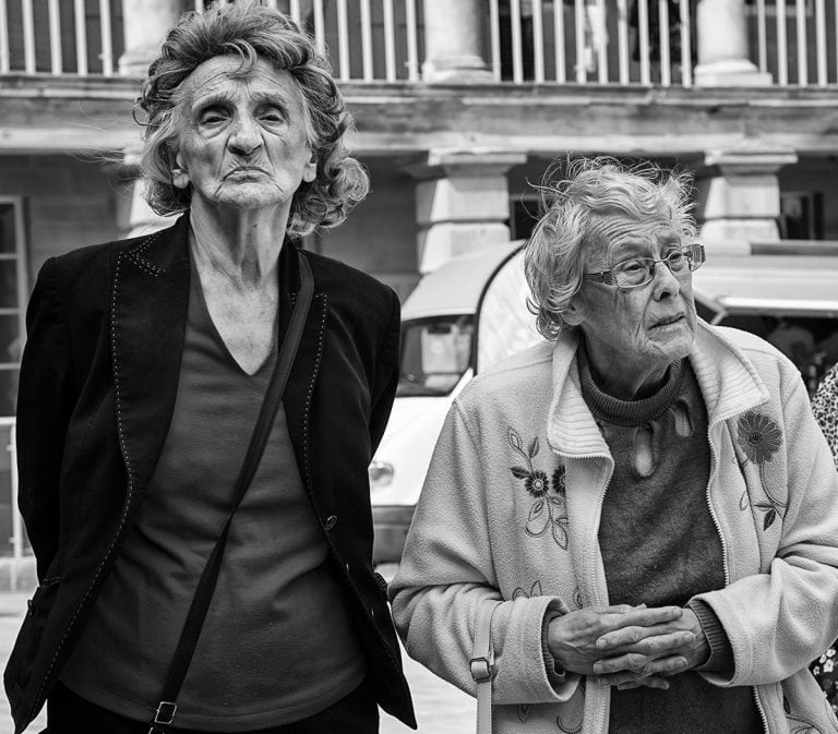 Two older women standing next to each other.