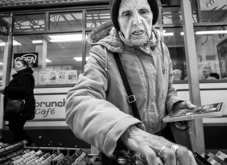 Street_Photography_Leeds_by John Gill-09 A woman in a black and white photograph.