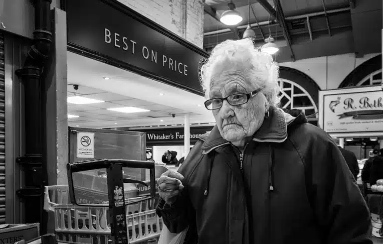Street_Photography_Leeds_by John Gill-13 An old lady in a grocery store.