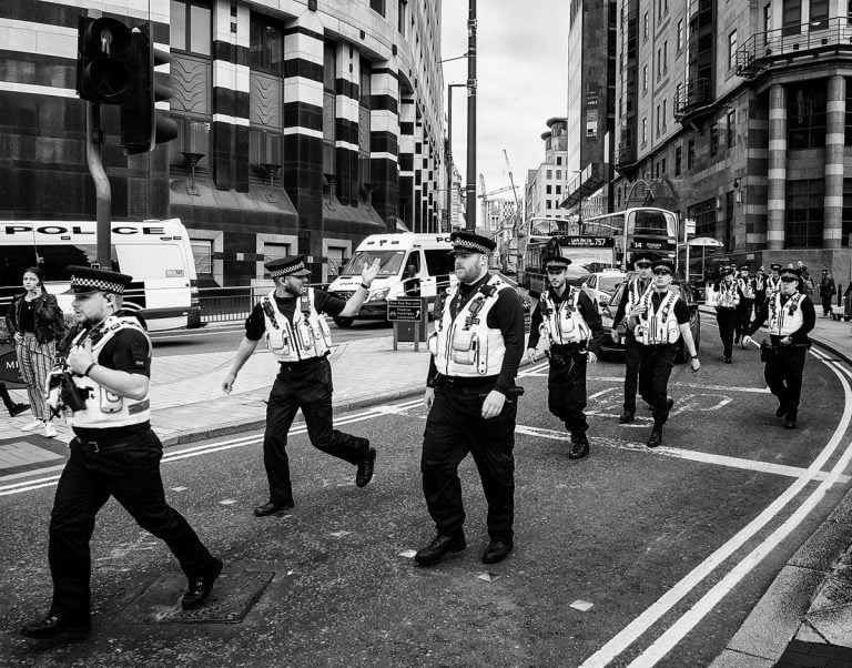 A group of police officers walking down the street.