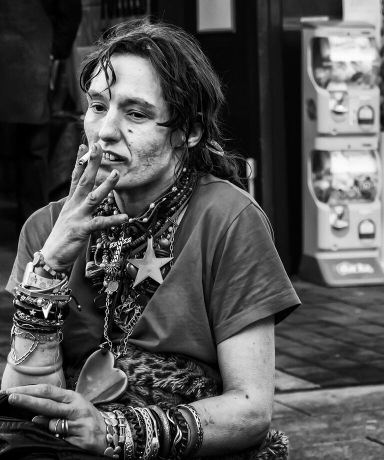 A black and white photo of a woman smoking a cigarette.