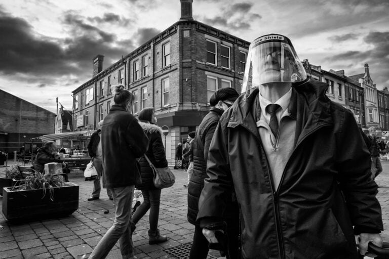 Black and white photograph of a man wearing a face mask.