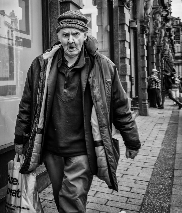 An old man walking down the street.