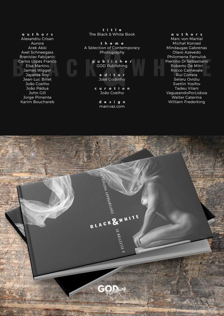 A black and white book on a wooden table.