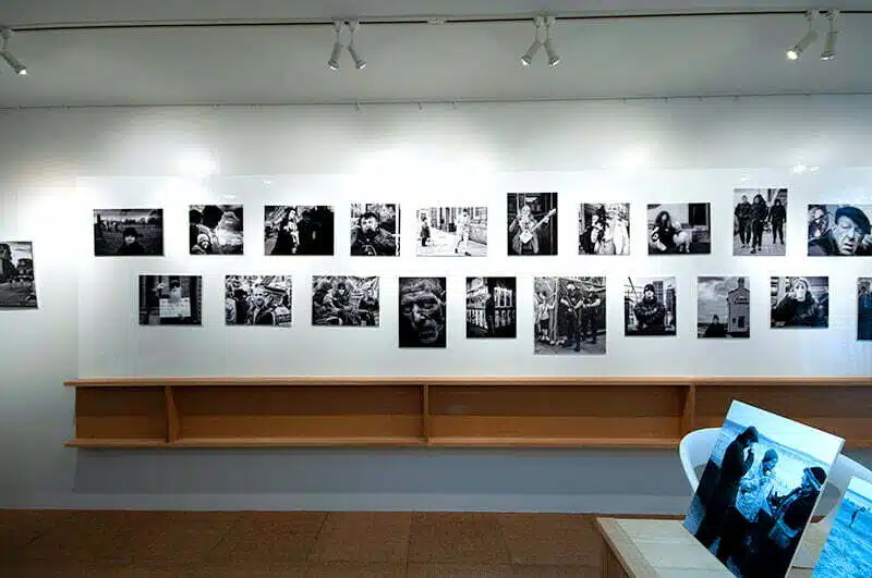 A room with black and white photographs on the wall.