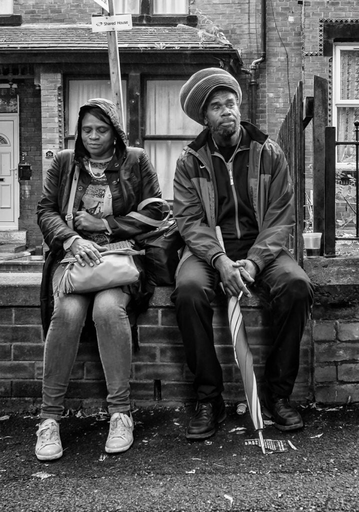 Couple sat on wall, Leeds UK