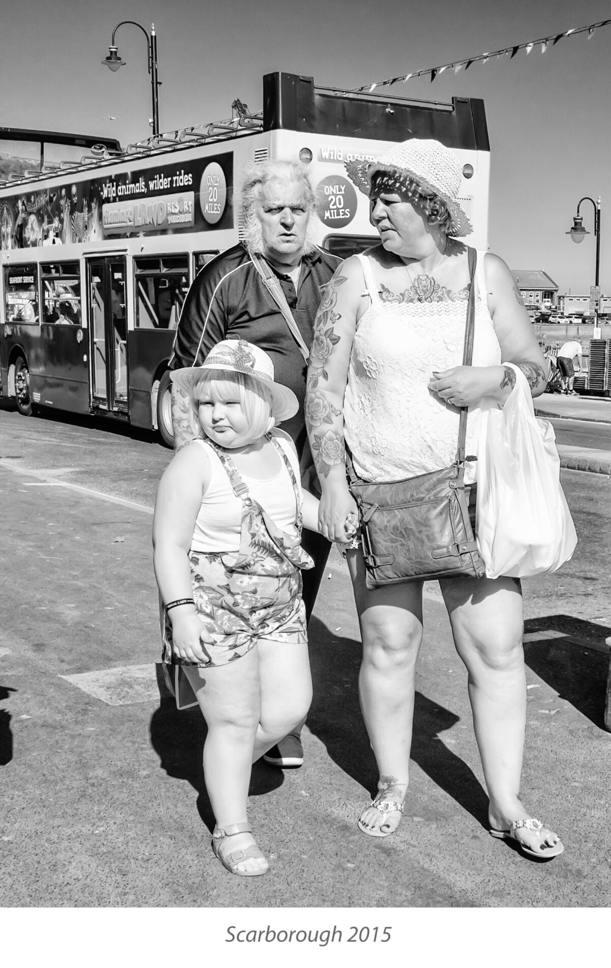 Family on Scarborough seafront with open top bus