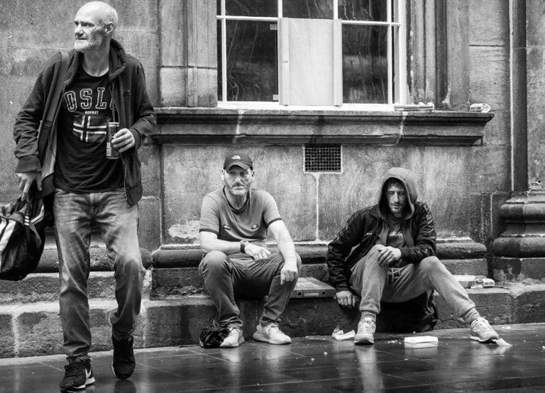 20230708-IMG_7009-Edit Black and white photo of a group of men on the street.