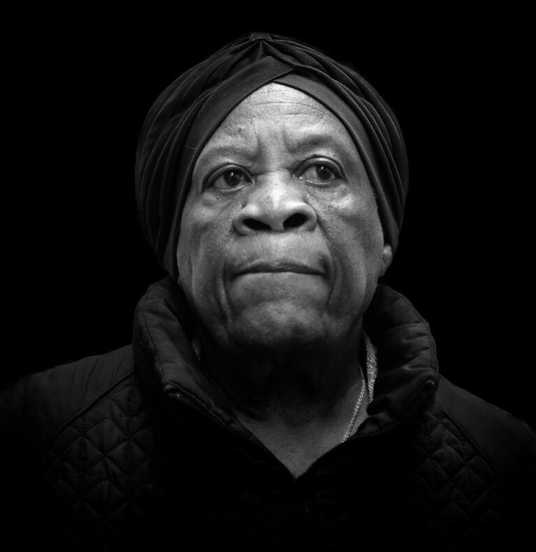 A black and white photo of a woman wearing a turban. A black and white photo of a woman wearing a turban.