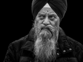 A black and white photo of a man in a turban.