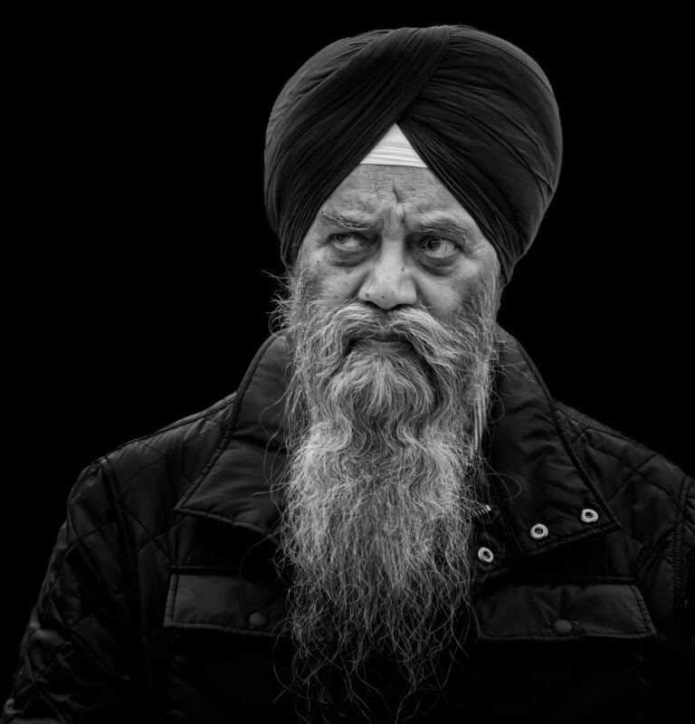 A black and white photo of a man in a turban. A black and white photo of a man in a turban.