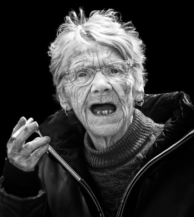 A black and white photo of an old woman. A black and white photo of an old woman.