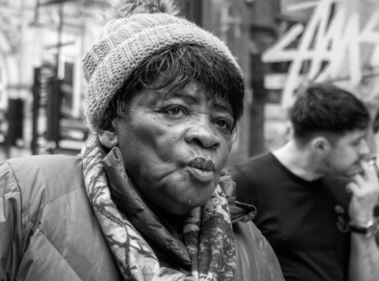 Black and white photograph of a woman on the street.