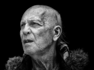 A black and white photo of an old man.