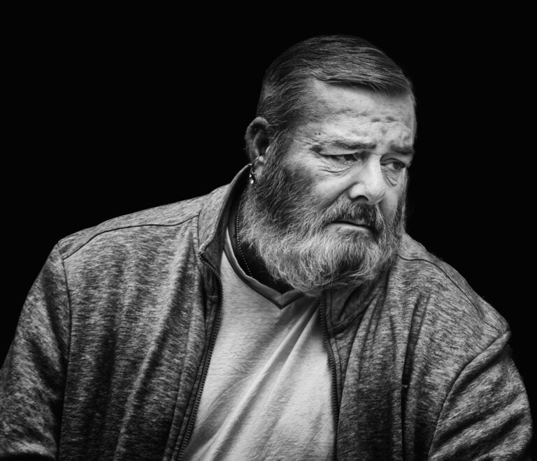 A black and white photo of a man with a beard. A black and white photo of a man with a beard.