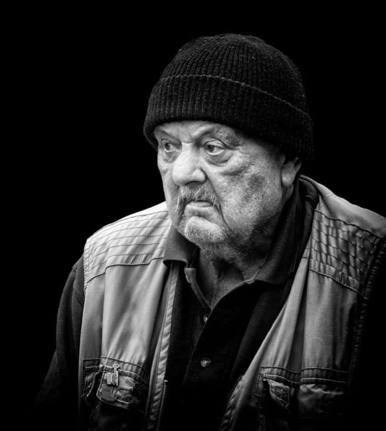 A black and white photo of an old man with a beanie. A black and white photo of an old man with a beanie.