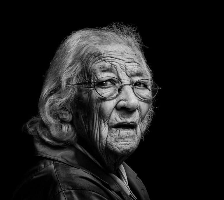 A black and white photo of an old woman. A black and white photo of an old woman.