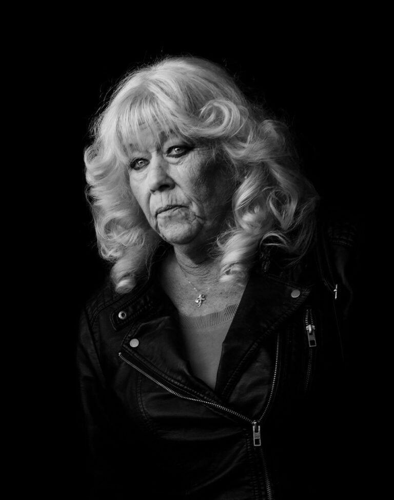 A black and white photo of a woman in a leather jacket. A black and white photo of a woman in a leather jacket.