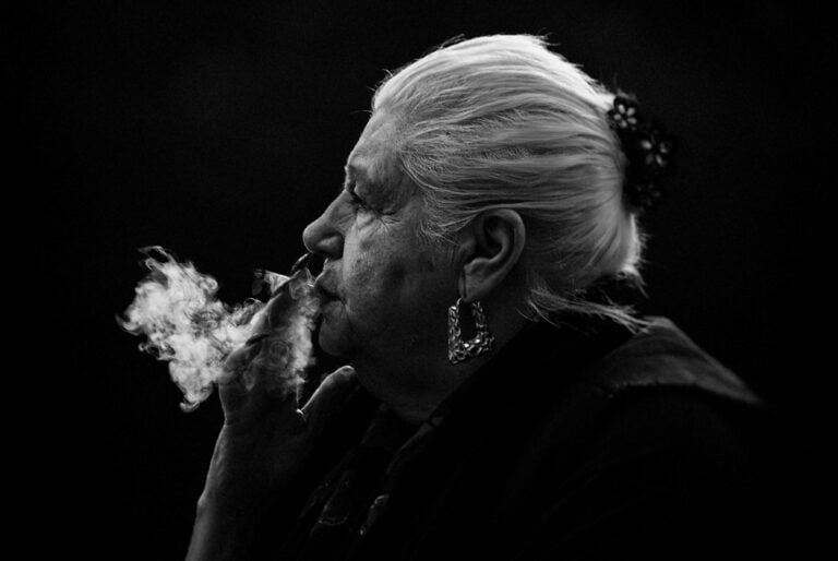 A woman smoking a cigarette in black and white. A woman smoking a cigarette in black and white.