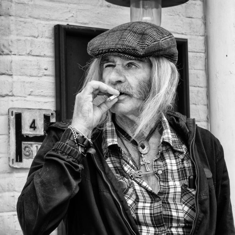 Black and white photograph of a man smoking a cigarette.