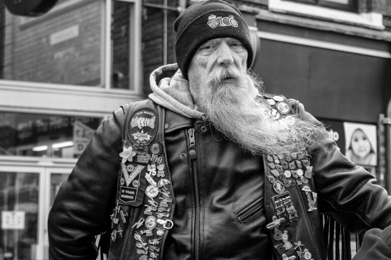 Black and white photo of a man with a long beard.
