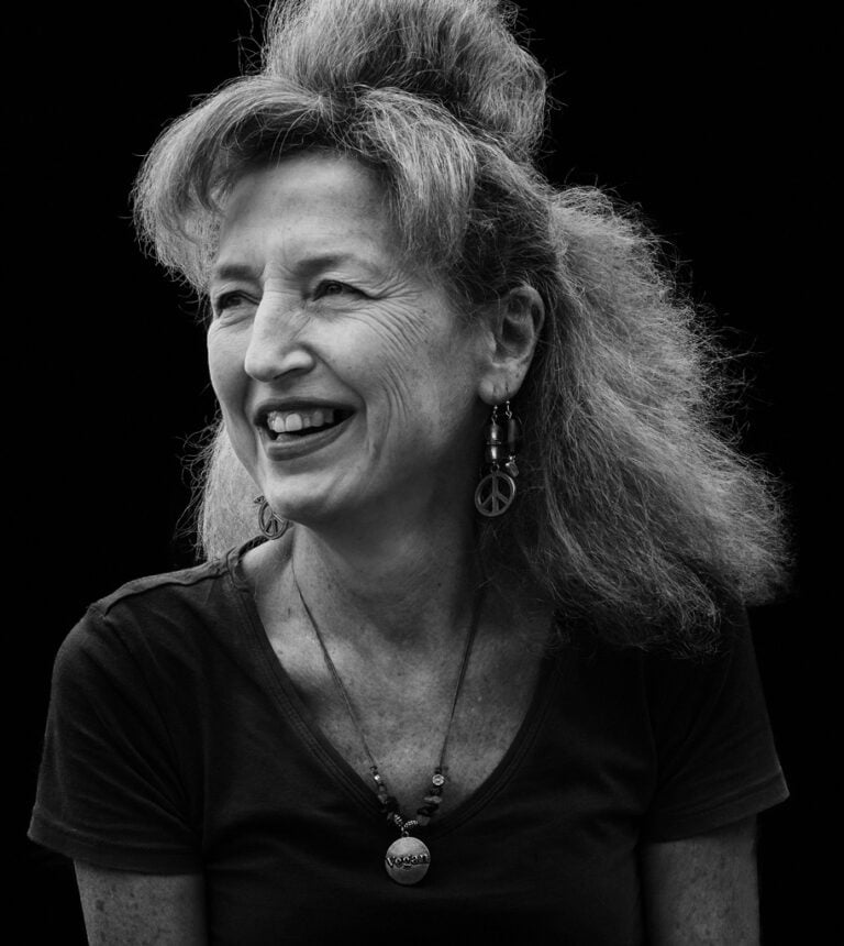 A black and white photo of a woman smiling. A black and white photo of a woman smiling.