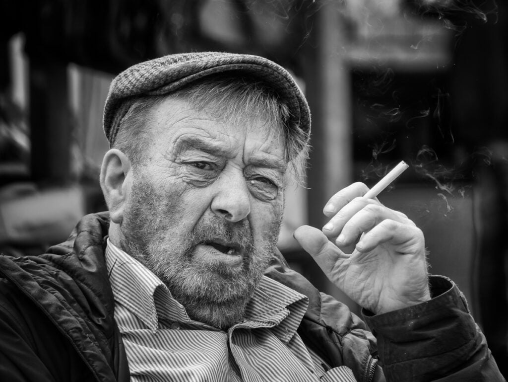 An old man smoking a cigarette.