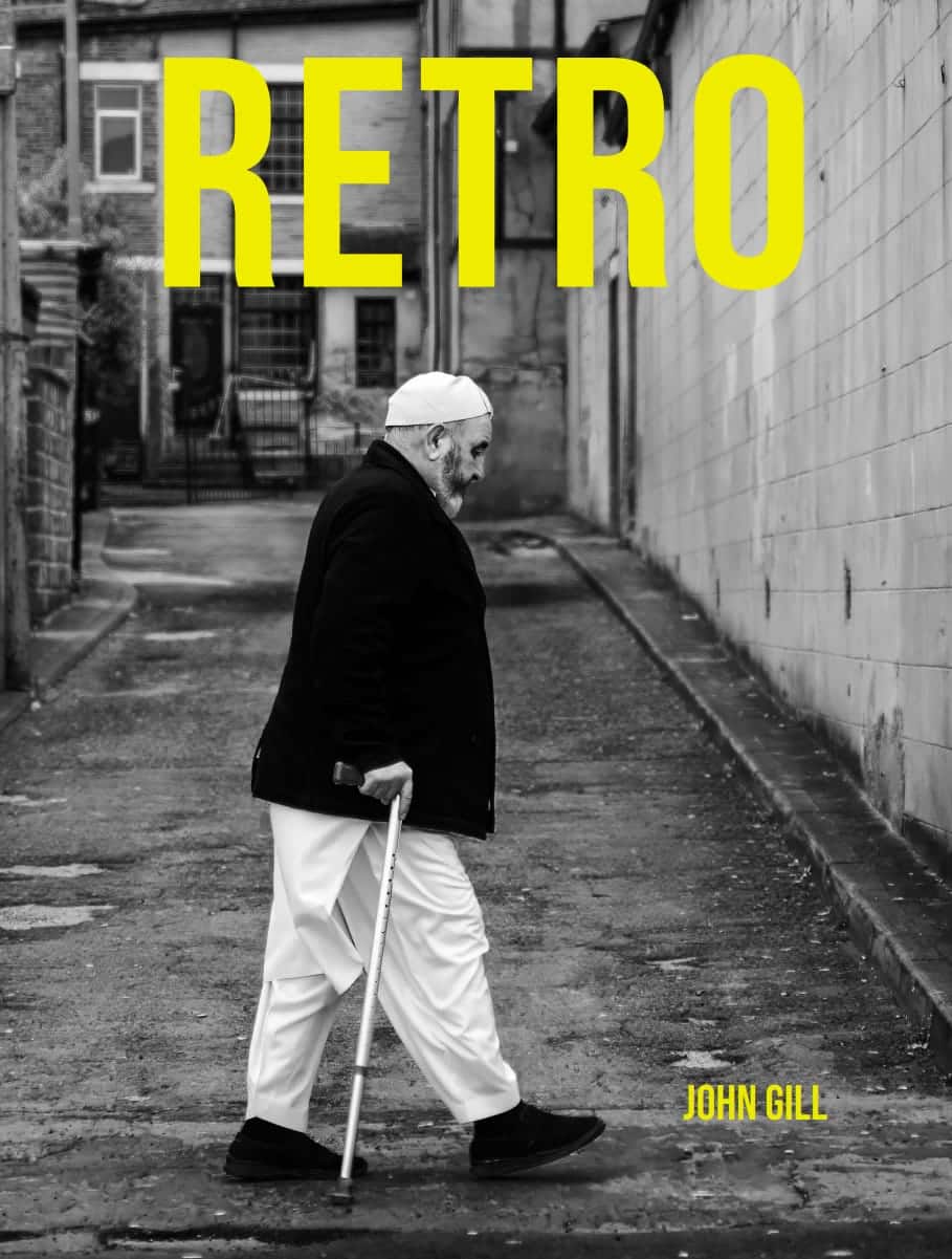Cover of the book Retro by John Gill: a black and white photograph of a man walking with a cane in an alley, with the word RETRO in yellow at the top.