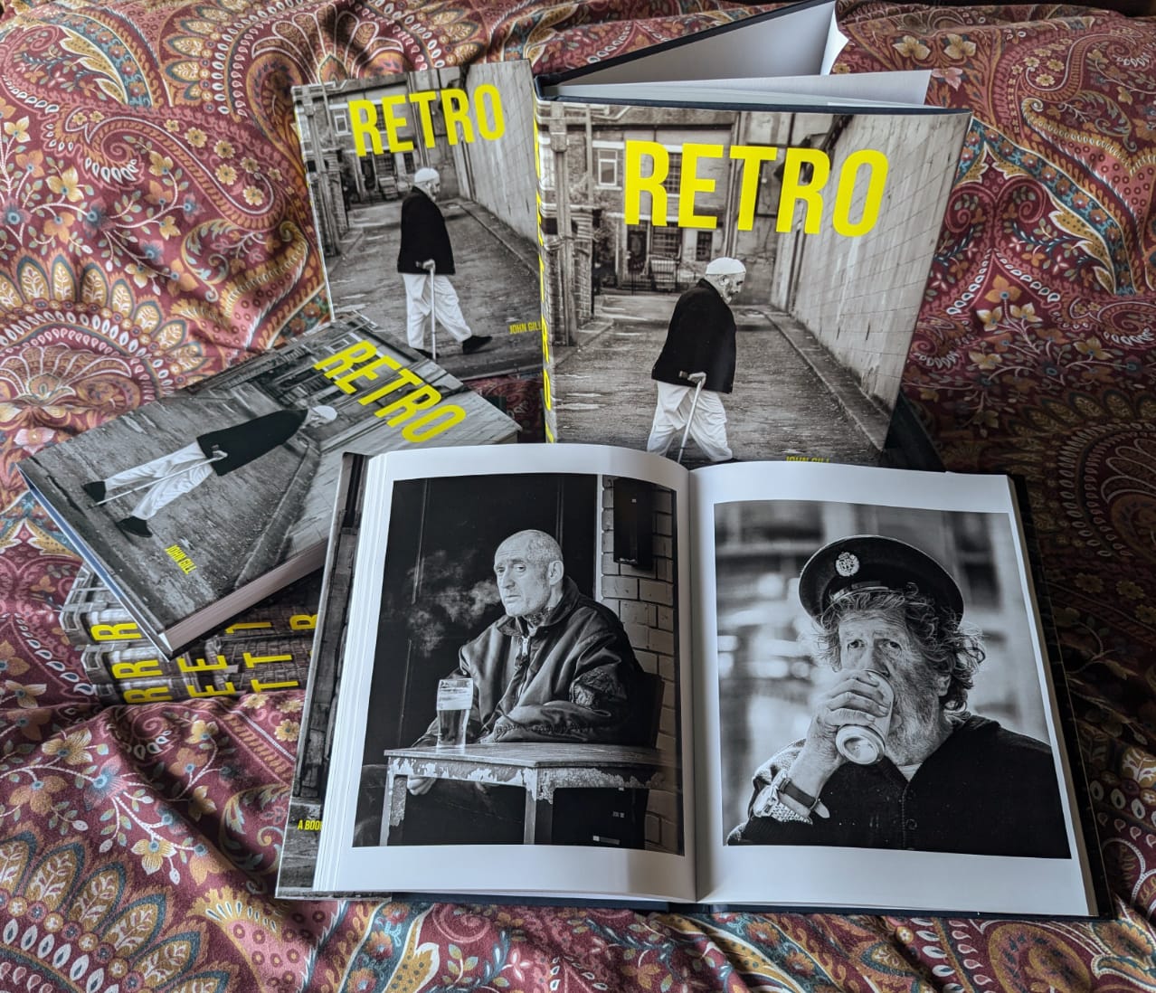 Several copies of Retro stacked on a patterned fabric surface.