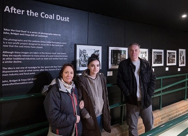 John, Bridget and Freya Gill in front of the After the Coal Dust exhibition panel at the National Coal Mining Museum for England.